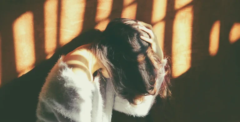 A woman holding her head as if she has a migraine.